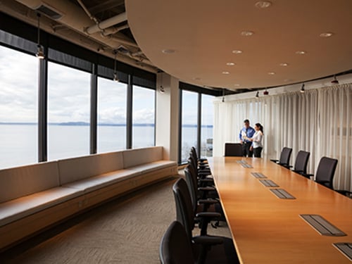 Male and female Hispanic American executives in a conference in a brightly lit large conference room