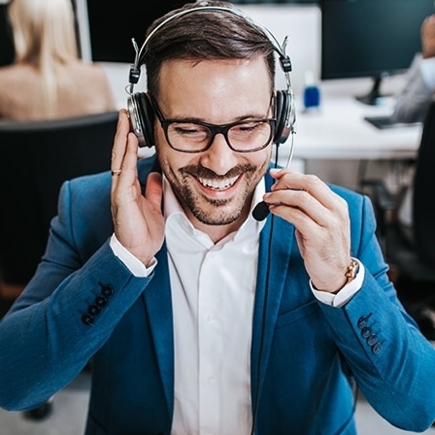 1180054097 Handsome male customer service agent working in call center office as a telemarketer.
