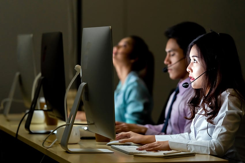 Agents with headsets working in a call center 